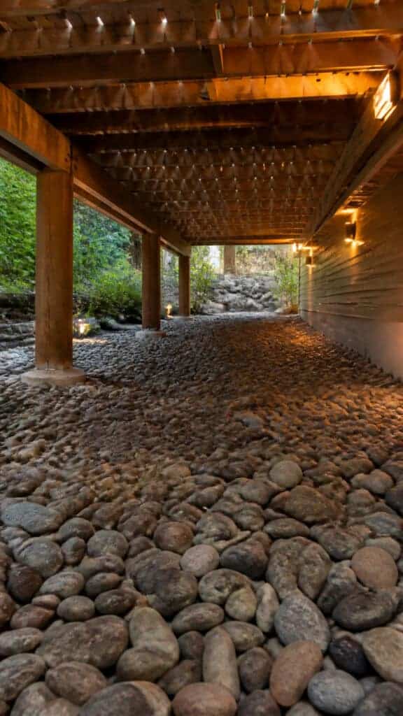 Install River Rock Under Deck Drainage